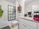 Well-lit bathroom featuring a granite vanity top, white cabinetry, and a shower with a black-framed glass door at 3862 Whitney Way, Haines City, FL 33844
