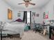 Bedroom with a unique bed frame, black out curtains, a ceiling fan, desk, and playful wall art at 3862 Whitney Way, Haines City, FL 33844