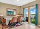 Comfortable dining area with a sliding glass doors leading to the backyard and colorful rug on tile floor at 3862 Whitney Way, Haines City, FL 33844