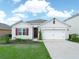Well maintained home featuring manicured landscaping, a two-car garage and an inviting entrance at 3862 Whitney Way, Haines City, FL 33844