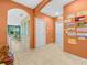 Bright hallway featuring artistic wall decorations and an archway leading to other rooms at 3862 Whitney Way, Haines City, FL 33844
