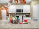 Bright kitchen featuring granite countertops, stainless appliances, and white cabinetry for a sleek, modern look at 3862 Whitney Way, Haines City, FL 33844