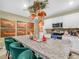 Open kitchen featuring a large granite island, white cabinets, stainless appliances, and stylish decor at 3862 Whitney Way, Haines City, FL 33844