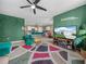 Bright living room showcasing open floor plan, green accent wall and modern decor at 3862 Whitney Way, Haines City, FL 33844