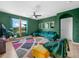 Stylish living room with cozy velvet sectional sofa, plants, and large windows at 3862 Whitney Way, Haines City, FL 33844