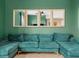Chic living room design featuring a comfortable green sofa and decorative mirrors on the wall at 3862 Whitney Way, Haines City, FL 33844
