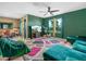 Stylish living room featuring vibrant green walls, modern furnishings, and abundant natural light at 3862 Whitney Way, Haines City, FL 33844