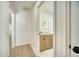Bright bathroom with modern vanity, illuminated mirror, and stylish geometric tile flooring at 409 Greenfield Rd, Winter Haven, FL 33884