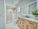 Updated bathroom featuring sleek vanity, and a glass enclosed shower with modern fixtures at 409 Greenfield Rd, Winter Haven, FL 33884