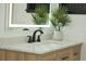 Bathroom vanity with white marble countertop, wooden drawers, modern faucet and lighting at 409 Greenfield Rd, Winter Haven, FL 33884