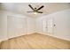 Bright bedroom with laminate floors, ceiling fan, closet with doors, and French doors at 409 Greenfield Rd, Winter Haven, FL 33884