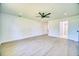 Bright, open bedroom with new laminate flooring, ceiling fan, and ensuite bathroom at 409 Greenfield Rd, Winter Haven, FL 33884