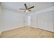 Bedroom with closet, laminate flooring, ceiling fan, and plenty of natural light at 409 Greenfield Rd, Winter Haven, FL 33884