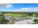 Aerial view of community pool and tennis courts, surrounded by lush landscaping and open space at 409 Greenfield Rd, Winter Haven, FL 33884