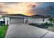 Charming single-story home featuring a two-car garage, long driveway, and well-manicured landscaping at 409 Greenfield Rd, Winter Haven, FL 33884