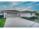 Charming single-story home with a two-car garage, a concrete driveway, and a well-maintained front yard at 409 Greenfield Rd, Winter Haven, FL 33884
