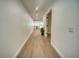Bright hallway with wood flooring leading to an open-concept layout and a view of a modern kitchen at 409 Greenfield Rd, Winter Haven, FL 33884