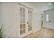 Bright hallway with a door to a room with French doors leading to another room at 409 Greenfield Rd, Winter Haven, FL 33884