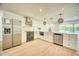 Updated kitchen featuring stainless appliances, white cabinets, stone countertops and a stylish backsplash at 409 Greenfield Rd, Winter Haven, FL 33884