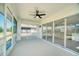 Covered lanai with ceiling fan, screens, and sliding glass doors for enjoying the outdoors at 409 Greenfield Rd, Winter Haven, FL 33884