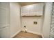 Laundry room with white cabinets and washer/dryer hookups, with modern, neutral flooring at 409 Greenfield Rd, Winter Haven, FL 33884