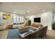 Bright living room featuring a white sofa, plush rug, and modern decor at 409 Greenfield Rd, Winter Haven, FL 33884