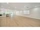 An open-concept living space featuring new floors, modern lighting, and large windows at 409 Greenfield Rd, Winter Haven, FL 33884