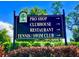 Community sign directing to the pro shop, clubhouse, restaurant and tennis/swim club at 409 Greenfield Rd, Winter Haven, FL 33884