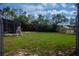 Large, grassy backyard featuring a screened-in structure, ideal for outdoor activities and gatherings at 420 N 5Th St, Lake Wales, FL 33853