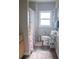 Cozy bathroom with a floral shower curtain, natural light, and a well-organized shelving unit at 420 N 5Th St, Lake Wales, FL 33853