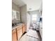 Bathroom with a vanity and cabinets offering storage, plus a shower with a floral curtain and modern fixtures at 420 N 5Th St, Lake Wales, FL 33853