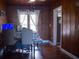Inviting dining area showcases natural wood paneling and hardwood floors, creating a warm and cozy atmosphere at 420 N 5Th St, Lake Wales, FL 33853