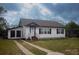 Charming one-story home featuring a well-maintained lawn and a classic white exterior, creating a welcoming curb appeal at 420 N 5Th St, Lake Wales, FL 33853