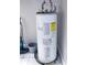 Hot water heater in a utility area with tile flooring and essential maintenance equipment nearby at 420 N 5Th St, Lake Wales, FL 33853