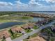 Beautiful aerial view of the home, landscaping, community, golf course, and nearby water features at 4279 Ashton Club Dr, Lake Wales, FL 33859