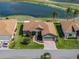 Aerial view of single-story home with beautiful landscaping, complemented by a serene pond and lush golf course backdrop at 4279 Ashton Club Dr, Lake Wales, FL 33859