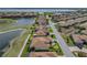Aerial view of home on golf course with water views and lush landscaping in a lake community at 4279 Ashton Club Dr, Lake Wales, FL 33859