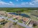 Aerial view of the home and surrounding area, near a lake, golf course, and green space at 4279 Ashton Club Dr, Lake Wales, FL 33859