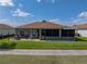 Charming single-story home featuring a brick patio and a cozy screened-in porch at 4279 Ashton Club Dr, Lake Wales, FL 33859