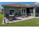 This backyard has a brick paver patio and a view of the screened in porch at 4279 Ashton Club Dr, Lake Wales, FL 33859