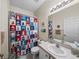 Bathroom featuring a nautical-themed shower curtain and vanity with ample lighting at 4279 Ashton Club Dr, Lake Wales, FL 33859