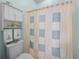 Compact bathroom with a toilet, decorative shower curtain, and storage shelves at 4279 Ashton Club Dr, Lake Wales, FL 33859
