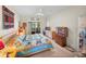 Bedroom featuring carpet floors, a TV, sliding glass doors, and a display case at 4279 Ashton Club Dr, Lake Wales, FL 33859