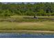 Scenic golf course community view with a pond, bridge, and lush greenery, ideal for an active lifestyle at 4279 Ashton Club Dr, Lake Wales, FL 33859