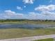 Scenic view of a golf course community with a pond and lush green surroundings, perfect for relaxation and recreation at 4279 Ashton Club Dr, Lake Wales, FL 33859