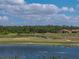 Breathtaking view of a golf course and pond, with homes nestled among the trees in a vibrant, active community at 4279 Ashton Club Dr, Lake Wales, FL 33859