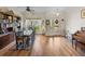 View of the dining room with hardwood floors, a large bookcase, and a decorative front door at 4279 Ashton Club Dr, Lake Wales, FL 33859