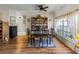 The dining room has hardwood floors, a large bookcase, and a decorative front door at 4279 Ashton Club Dr, Lake Wales, FL 33859