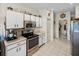 Efficient kitchen featuring white cabinets, tile floors, and modern appliances at 4279 Ashton Club Dr, Lake Wales, FL 33859