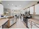 Bright kitchen with white cabinets, stainless steel appliances, and an adjacent breakfast nook at 4279 Ashton Club Dr, Lake Wales, FL 33859